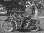Trooper on early motorcycle